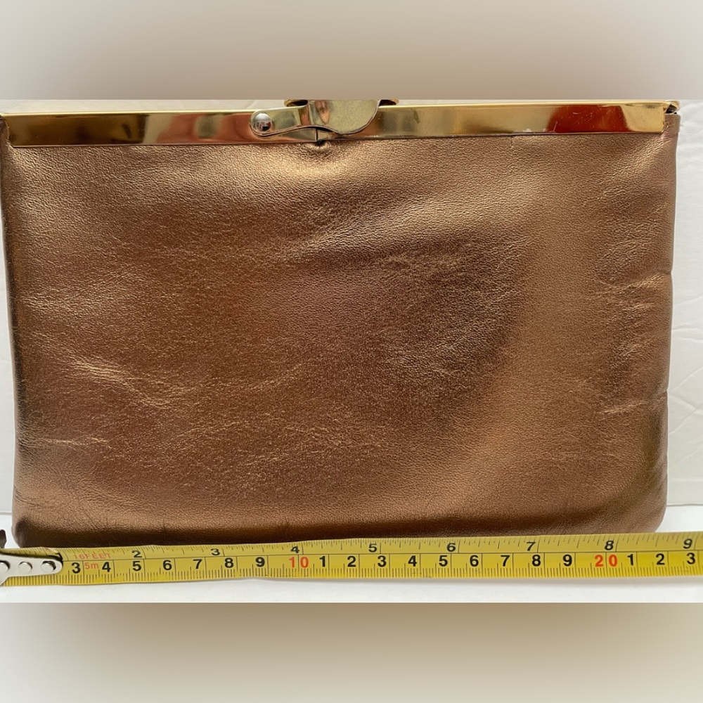 Vintage metallic gold/bronze clutch with 3”chain handle. Some wear.